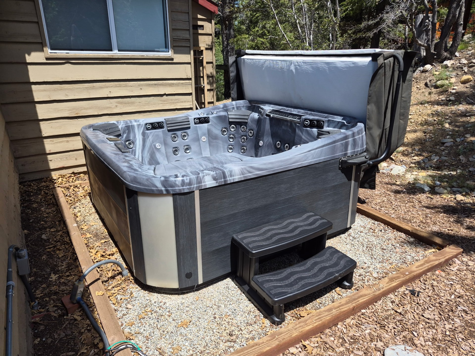 Artesian Elite hot tub delivered and set up beside a Big Bear cabin