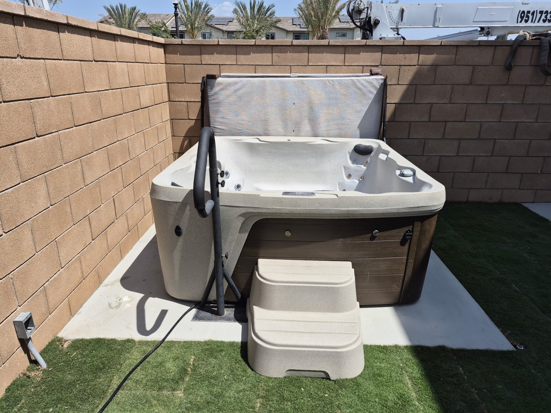 Hot tub craned into a walled Ontario backyard after the move from Chino Hills