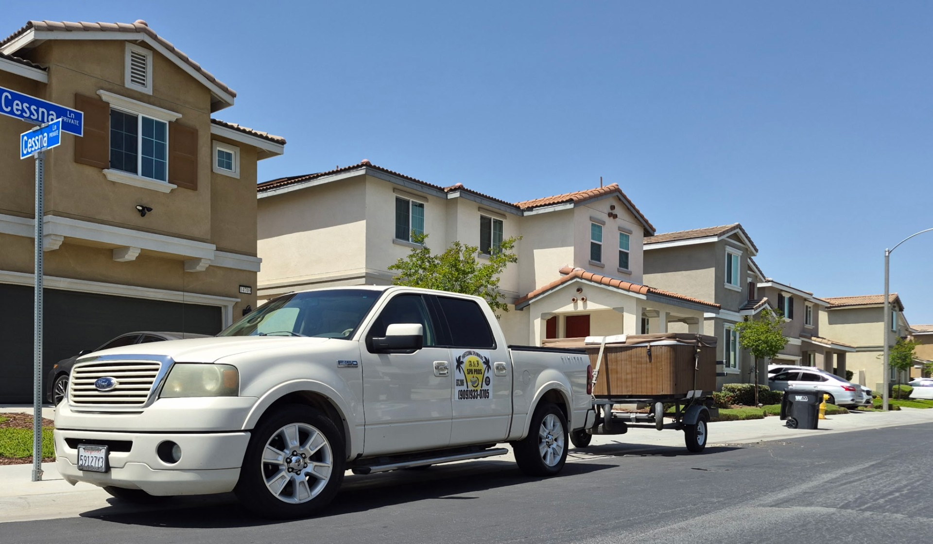 A&J Spa Pros truck and trailer staged in a Moreno Valley neighborhood before the Riverside delivery
