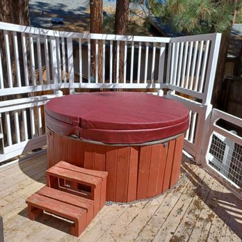Round wooden spa on a deck